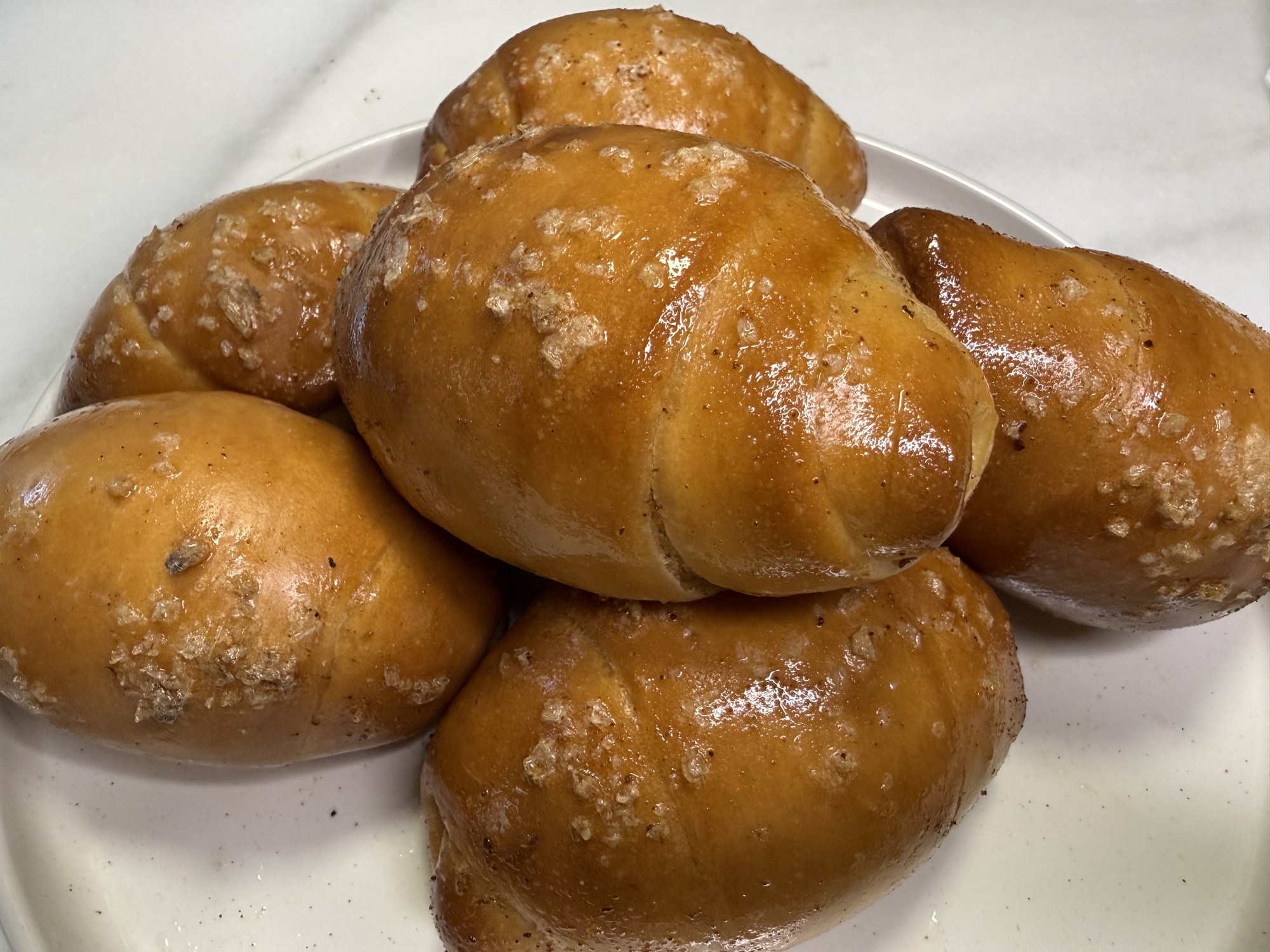 Fresh Korean salt bread rolls baked in Trumbull, Connecticut, dusted with flaky sea salt